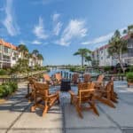 Beautiful outdoor seating area with Adirondack chairs overlooking the water at 220 Santa Maria Stree.