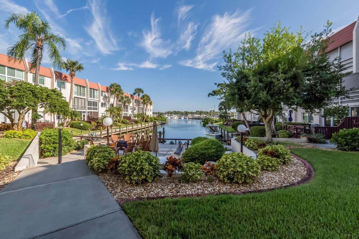 Beautiful waterfront view of 220 Santa Maria Street with lush landscaping and serene waterway.