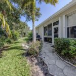 Backyard garden with tropical plants and a stone pathway, perfect for outdoor relaxation.