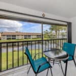 Balcony overlooking water and neighboring homes at 345 Three Lakes Lane.