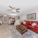 Bright living room with red sofa and modern decor at 345 Three Lakes Lane.