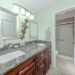 Bathroom with double sink vanity and accessible walk-in shower at 345 Three Lakes Lane.