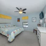 Bright bedroom with comfortable bedding and cheerful yellow window valances.