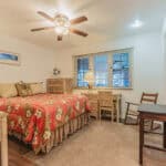 Bright bedroom with comfortable bed and natural light, ideal for relaxing in Port Charlotte.