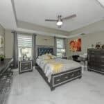Spacious bedroom featuring contemporary furniture and natural light in Venice, FL.