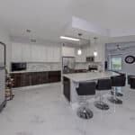 Bright, open-concept kitchen featuring a large island, sleek cabinetry, and contemporary appliances.