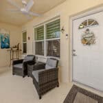 Inviting porch area with wicker chairs in Venice, FL.