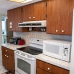 Kitchen with wooden cabinets and modern appliances in Venice, FL.