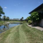 Waterfront home at 1606 Cypress Point Court Venice FL with lush landscaping and scenic water views.