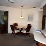 Bright interior dining space with round table and four chairs in Venice, Florida.